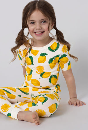 A closeup of A girl wearing White and Yellow Short Sleeve Stretch Jersey Kids Pj Set