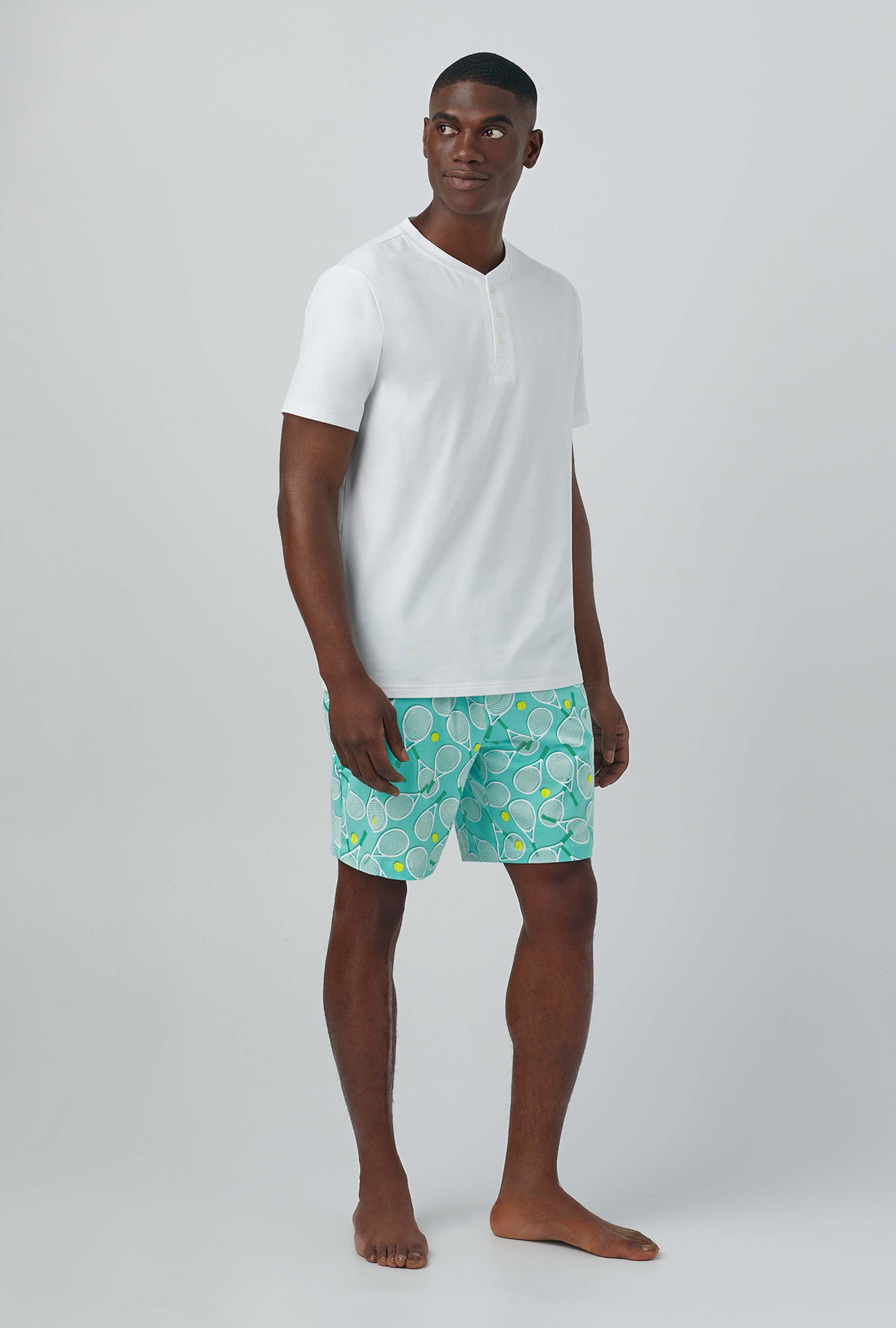 A man wearing green Short Sleeve Henley Stretch Jersey PJ Set with Tennis Club print