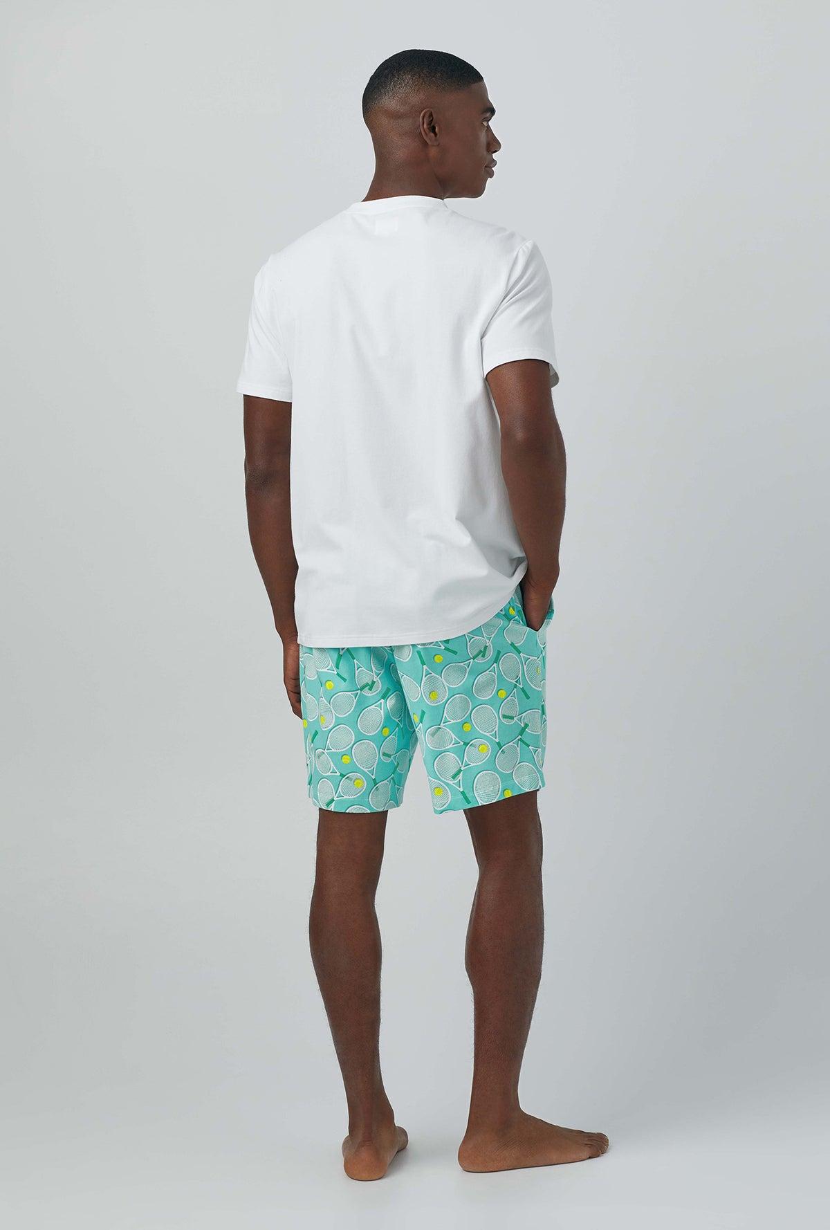 A man wearing green Short Sleeve Henley Stretch Jersey PJ Set with Tennis Club print