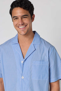 A Man Wearing French Stripe Men's Short Sleeve Woven Supersoft Cotton Poplin Short Pj Set in a close up smiling pose