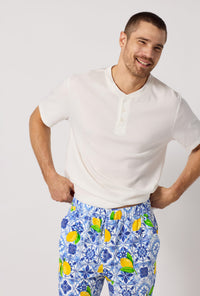 A closeup of A man wearing Blue and White Men's Short Sleeve Henley Stretch Jersey Short Pj Set