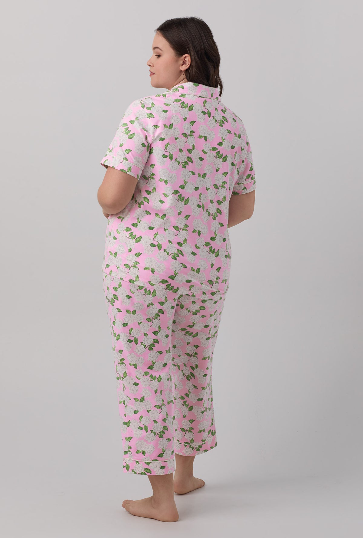 A lady wearing plus size  pink Hydrangea Short Sleeve Classic Stretch Jersey Cropped PJ Set with Pink Summer print.
