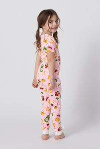 A girl wearing Pink Short Sleeve Stretch Jersey Kids Pj Set side view