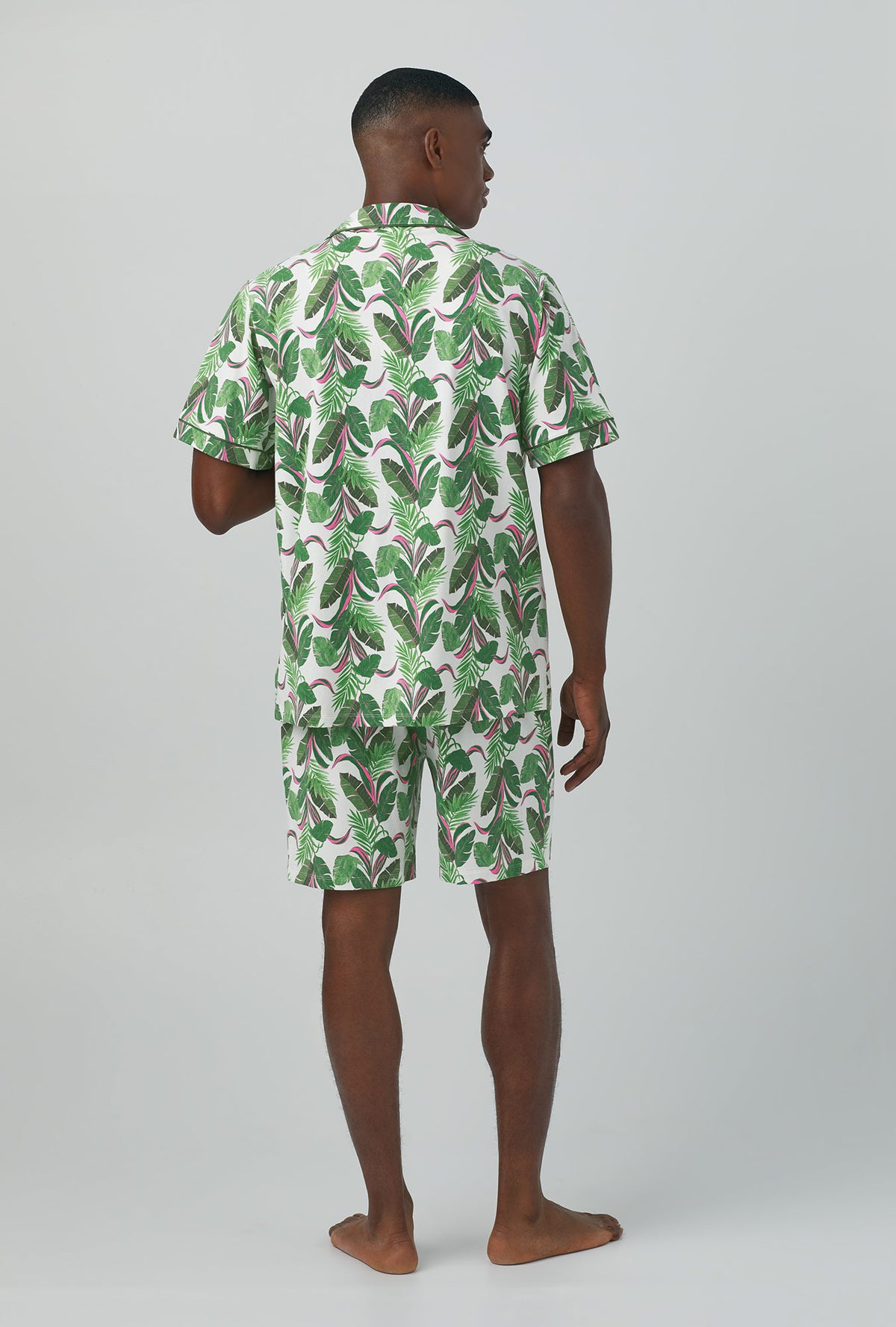 A man wearing green Short Sleeve Notch Stretch Jersey Short PJ Set with Palm Valley print