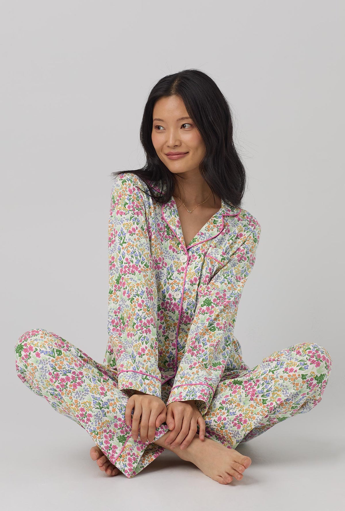 A lady wearing multi color long sleeve classic stretch jersey pj set with cottage garden print.