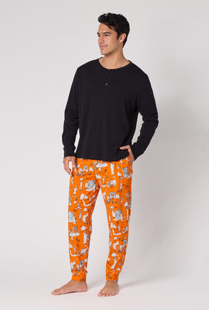 A Man Wearing Orange Spooky In The City Men's Long Sleeve Henley And Jogger Stretch Jersey Pj Set in a side angled pose