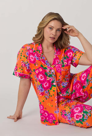 A lady sitting with a pose wearing plus size Orange Short Sleeve Classic Stretch Jersey Cropped Pj Set front view