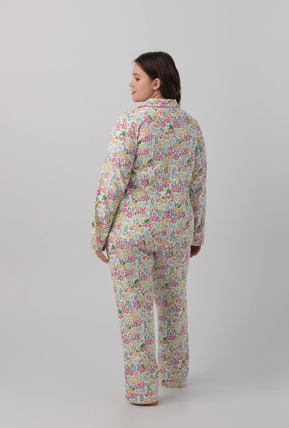 A lady wearing multi color long sleeve classic stretch jersey plus size pj set with cottage garden print.