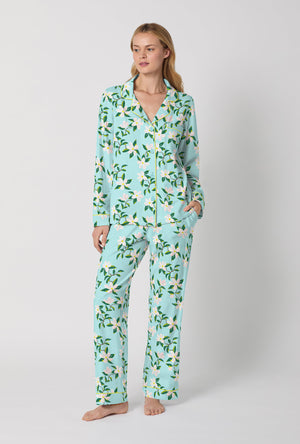 A Lady Wearing Blue Long Sleeve Classic Stretch Jersey PJ Set with Belle Blossoms Print Front View