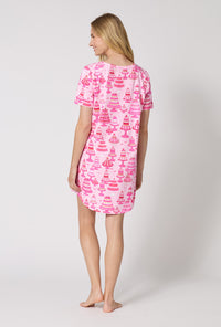 A Lady Wearing Cake Shop Stretch Jersey T-shirt Sleep Dress in a back view pose