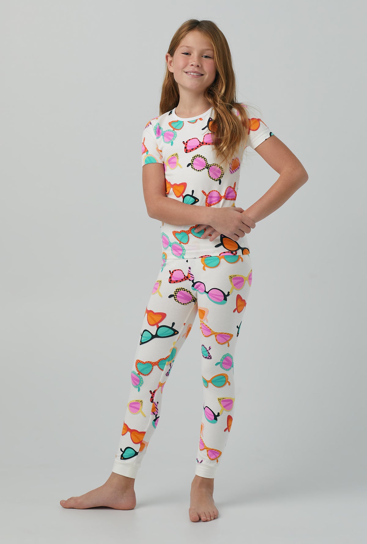 A girl wearing multi color Short Sleeve Stretch Jersey Kids PJ Set with sunny lens print
