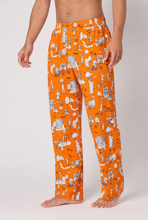 A Man Wearing Orange Spooky In The City Men's Stretch Jersey Pj Pant in a side angled pose