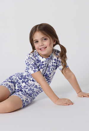 A little girl wearing Under The Sea Short Sleeve Stretch Jersey Kids Short Pj Set closer look sitting on floor
