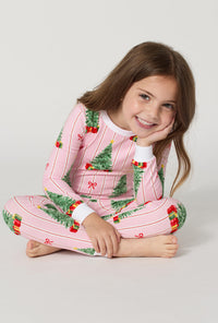 A girl wearing Pretty In Pine Long Sleeve Stretch Jersey Kids Pj Set sitting down