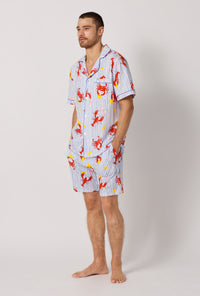 A man wearing Coastal Feast Men's Short Sleeve Classic Stretch Jersey Short Pj Set looking side