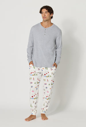 A man wearing Snow Much Fun Men's Long Sleeve Henley And Jogger Stretch Jersey Pj Set