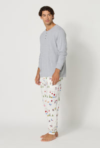 A man wearing Snow Much Fun Men's Long Sleeve Henley And Jogger Stretch Jersey Pj Set looking side