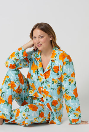 A lady wearing plus size Golden Breeze Long Sleeve Classic Stretch Jersey Pj Set sitting