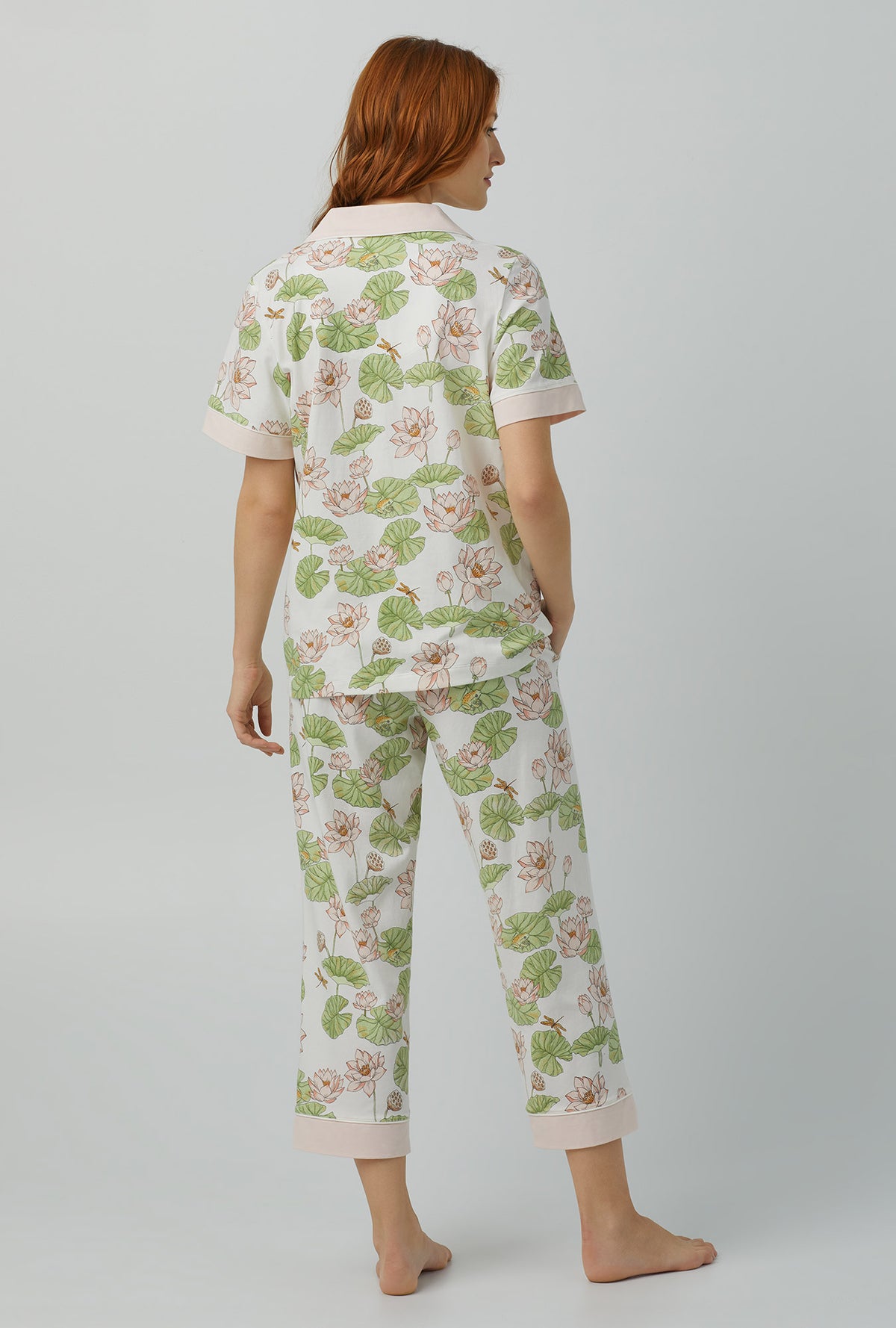 A lady wearing Short Sleeve Classic Stretch Jersey Cropped PJ Set with lily pond print