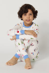 A boy Snow Much Fun Long Sleeve Stretch Jersey Kids Pj Set sitting down