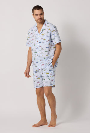 A man wearing Catch A Wave, Snoopy Men's Short Sleeve Woven Cotton Poplin Short Pj Set looking down