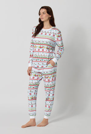 A lady wearing Peanuts® Winter Parade Long Sleeve Pullover Crew And Jogger Stretch Jersey Pj Set looking sdie
