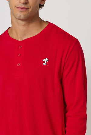 A man wearing Peanuts® Winter Parade Men's Long Sleeve Henley And Jogger Stretch Jersey Pj Set closer look