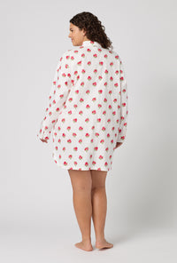 A Lady Wearing Plus Size Celeste High Low Woven Supersoft Cotton Poplin Boyfriend Shirt in a back view pose