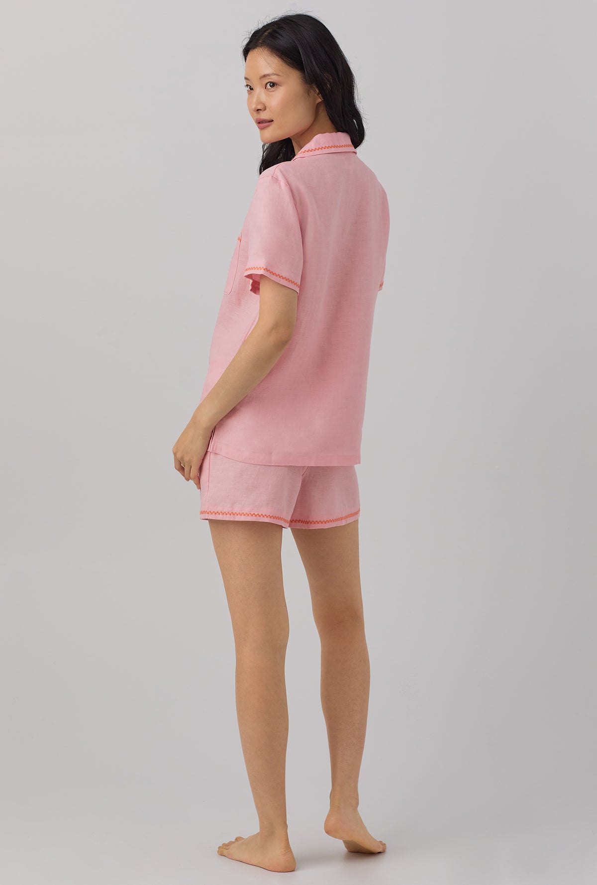 A lady wearing pink Short Sleeve Classic Shorty Woven Linen PJ Set with Orchid Pink print.