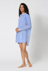 A Lady Wearing French Stripe High Low Woven Supersoft Cotton Poplin Boyfriend Shirt in a side angled pose