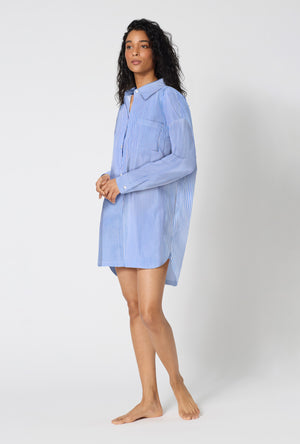 A Lady Wearing French Stripe High Low Woven Supersoft Cotton Poplin Boyfriend Shirt in a side angled pose