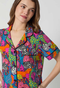 A lady wearing BedHead x Trina Turk Jungle Short Sleeve Classic Shorty Stretch Jersey Pj Set