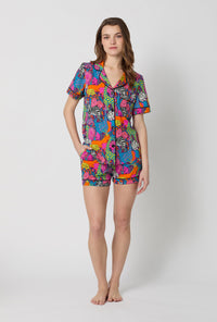 A lady wearing BedHead x Trina Turk Jungle Short Sleeve Classic Shorty Stretch Jersey Pj Set
