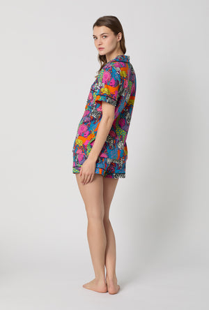 A lady wearing BedHead x Trina Turk Jungle Short Sleeve Classic Shorty Stretch Jersey Pj Set