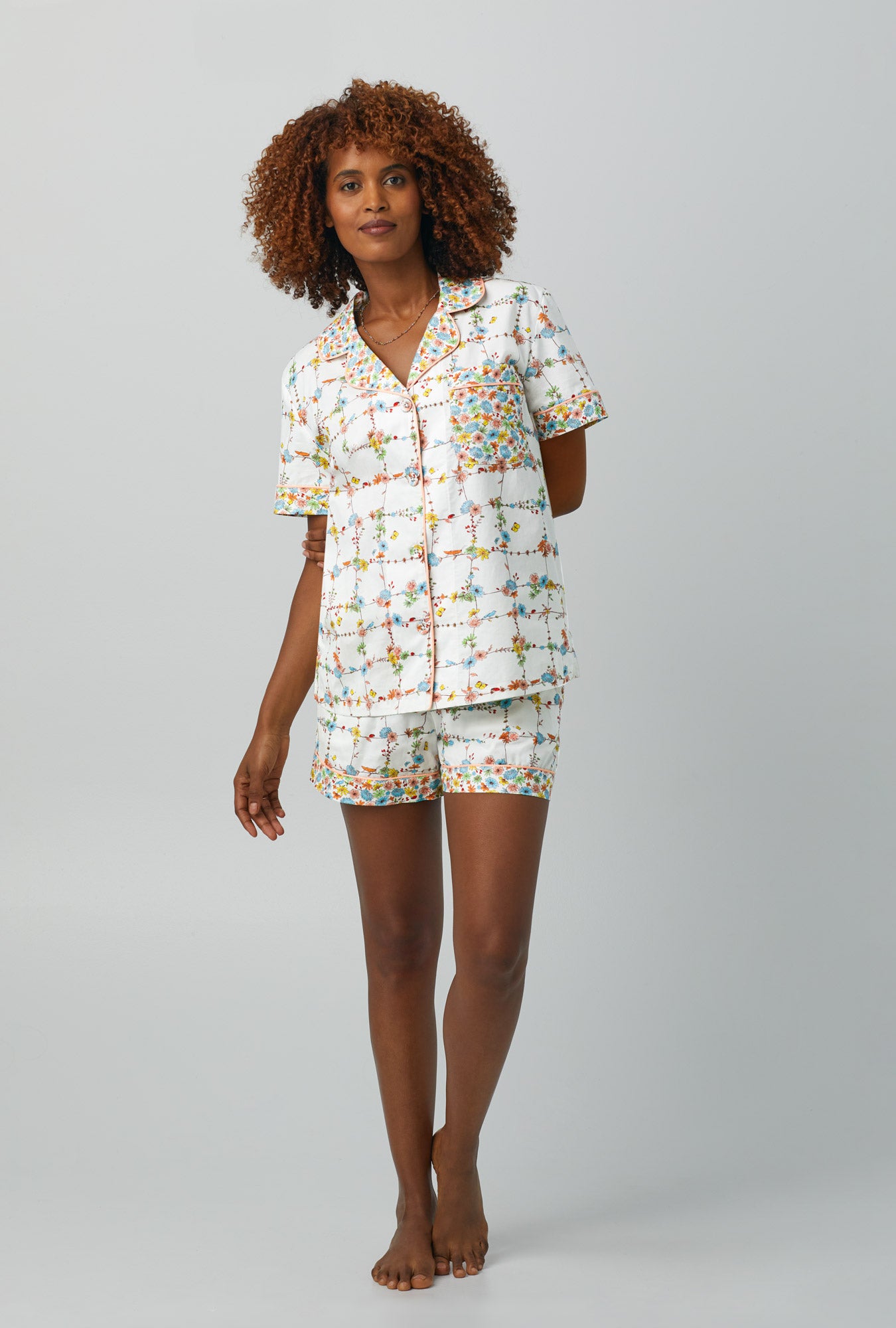 A lady wearing Short Sleeve Classic Shorty Woven Cotton Poplin PJ Set with spring vines print