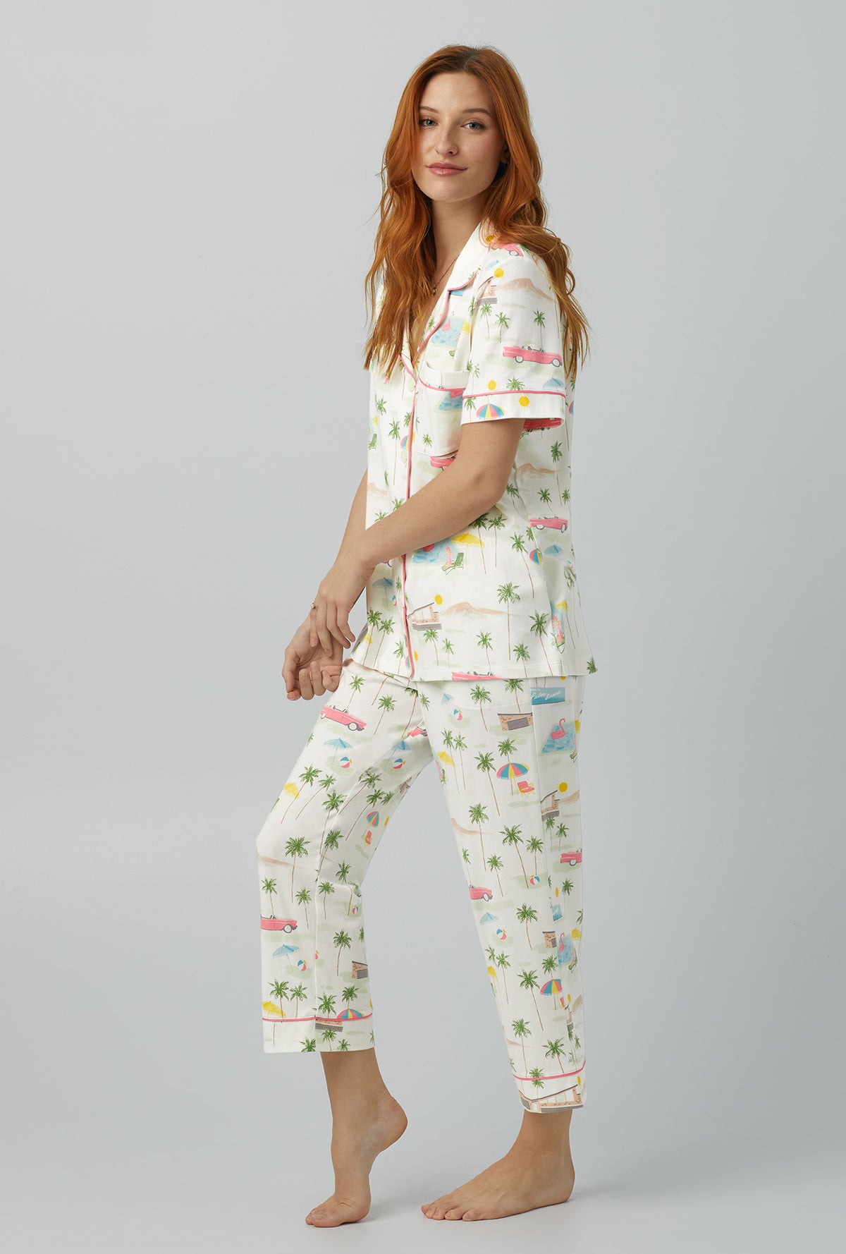 A lady wearing white Short Sleeve Classic Stretch Jersey Cropped PJ Set with Welcome to Palm Springs print