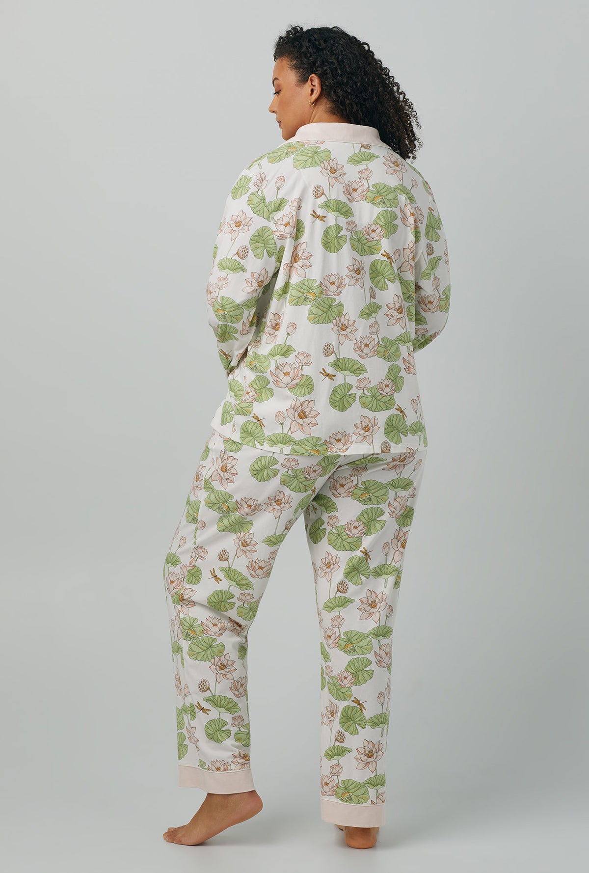 A lady wearing white Long Sleeve Classic Stretch Jersey PJ Set with lily pond print