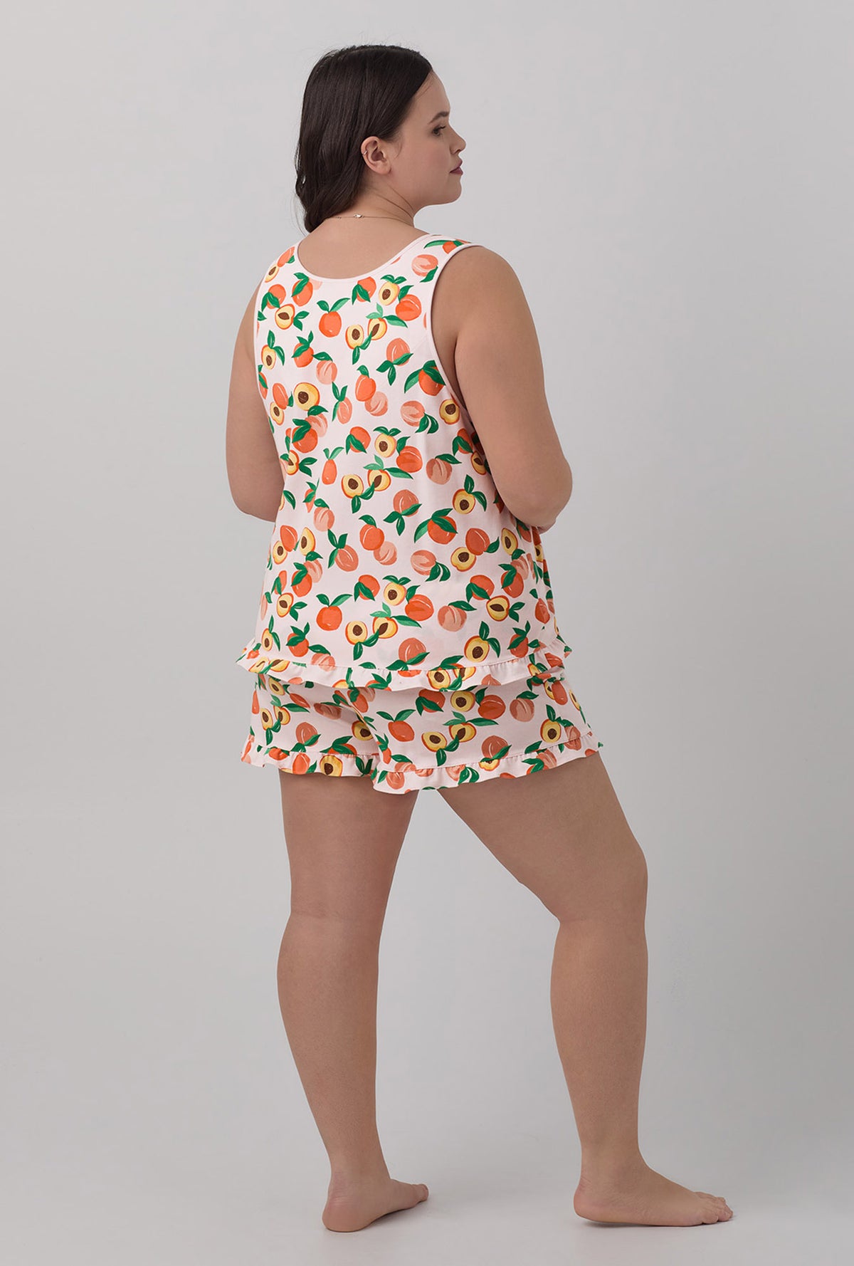 A lady wearing Ruffle Tank Shorty Stretch Jersey PJ Set with peachy keen print