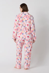 A Lady Wearing Plus Size Serene Sunrise Long Sleeve Classic Stretch Jersey Pj Set in a back view pose
