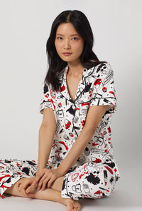 A lady wearing Devil Wears Prada Short Sleeve Classic Stretch Jersey Cropped Pj Set closer look sitting