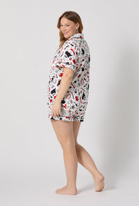 A lady wearing plus size Devil Wears Prada Short Sleeve Classic Shorty Stretch Jersey Pj Set back view