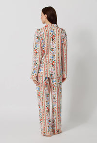 A lady wearing Rifle Paper Co. x BedHead PJs Holly Jolly Nutcracker Long Sleeve Classic Stretch Jersey Pj Set back view