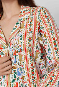 A lady wearing Rifle Paper Co. x BedHead PJs Holly Jolly Nutcracker Long Sleeve Classic Stretch Jersey Pj Set closer look