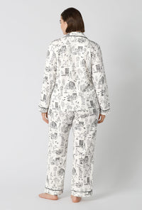 A Lady Wearing Plus Size White Spooky In The City Long Sleeve Classic Stretch Jersey Pj Set in a back view pose