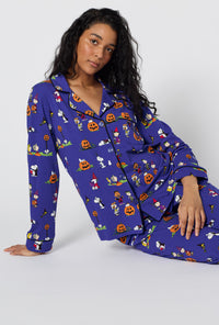 A Lady Wearing Spooky Season Snoopy Long Sleeve Classic Stretch Jersey Pj Set in a sitting pose
