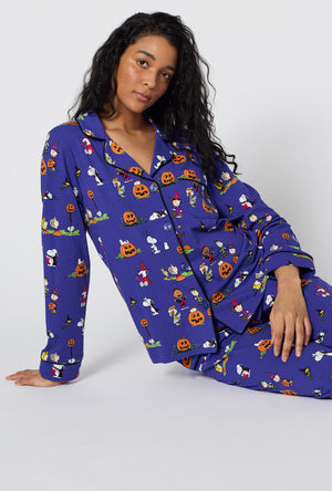 A Lady Wearing Spooky Season Snoopy Long Sleeve Classic Stretch Jersey Pj Set in a sitting pose