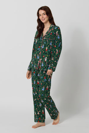 A lady wearing Rifle Paper Co. x BedHead PJs Nutcracker Long Sleeve Classic Stretch Jersey Pj Set walking