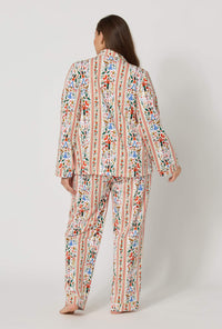 A lady wearing plus size Rifle Paper Co. x BedHead PJs Holly Jolly Nutcracker Long Sleeve Classic Stretch Jersey Pj Set back view
