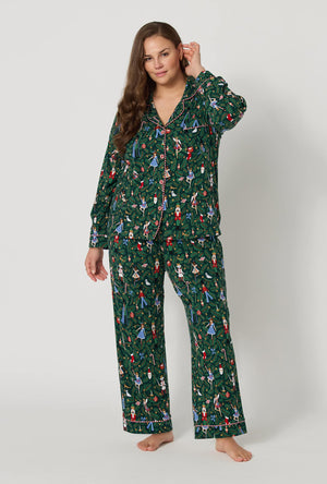 A lady wearing plus size Rifle Paper Co. x BedHead PJs Nutcracker Long Sleeve Classic Stretch Jersey Pj Set