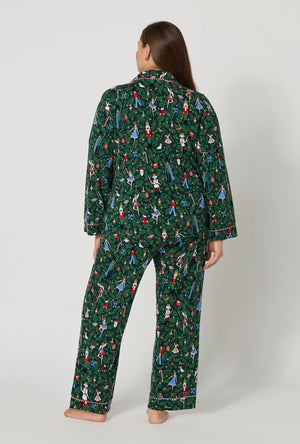 A lady wearing plus size Rifle Paper Co. x BedHead PJs Nutcracker Long Sleeve Classic Stretch Jersey Pj Set back view